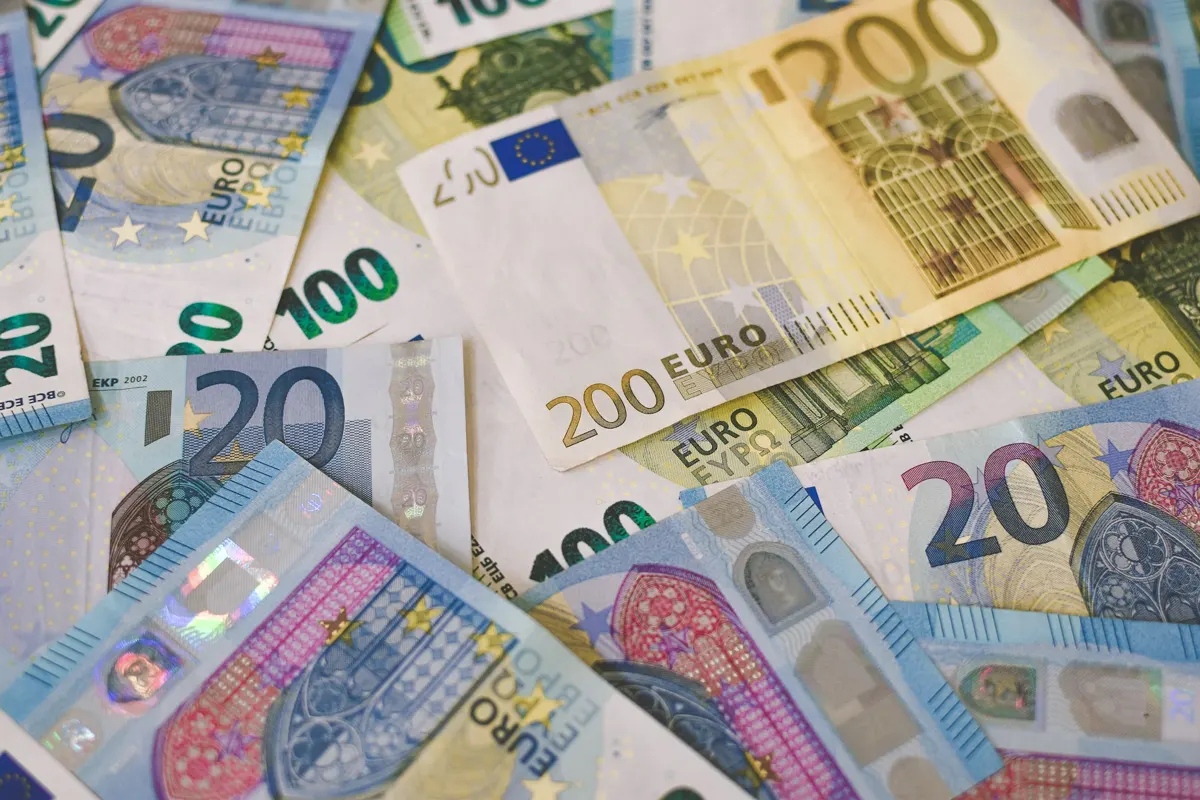 Scattered euro banknotes of various denominations